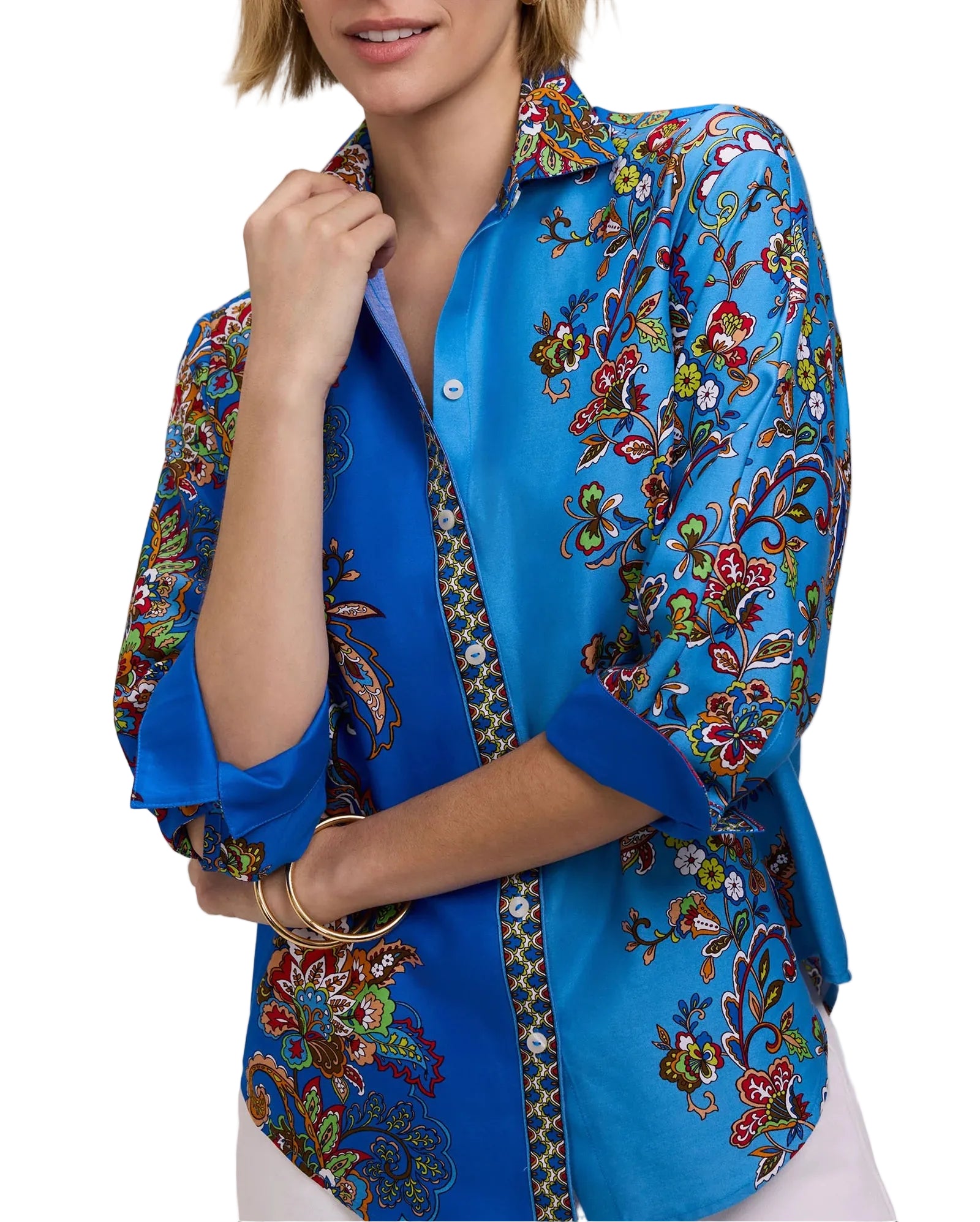 Woman wearing a blue floral patterned blouse on a white background
